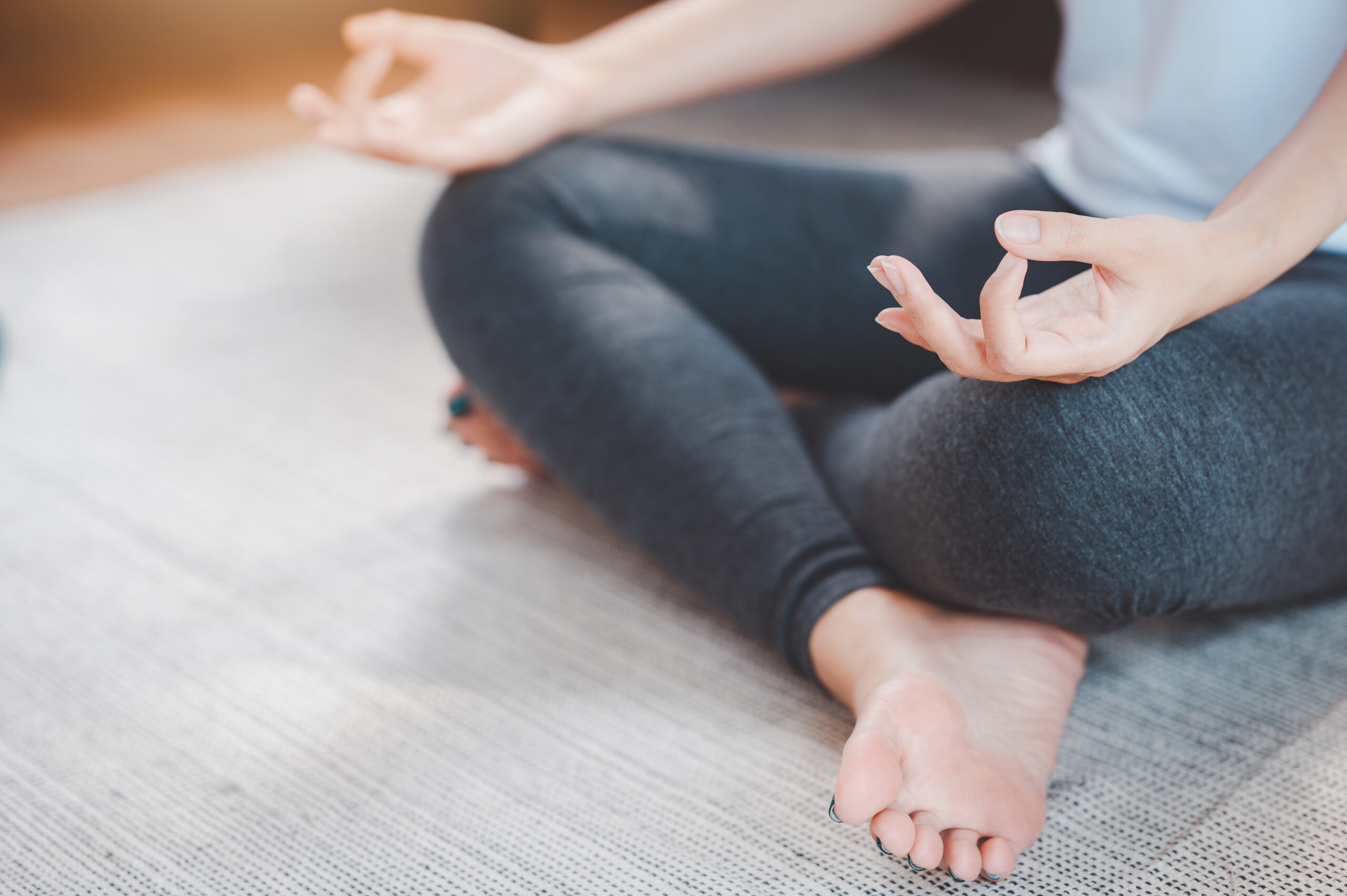 woman practicing yoga meditation at home
